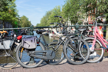 Fototapeta na wymiar Bicycles at a bridge over an Amsterdam canal