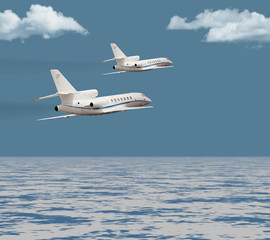 Fototapeta na wymiar Two private jets flying over the ocean