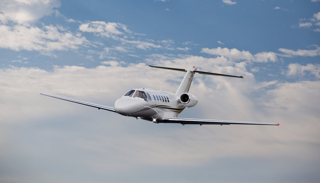 Fototapeta Private jet in the air with clouds in the background