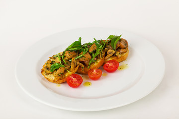 Bruschetta with mushrooms and cherry tomatoes basil on a plate isolated for the menu