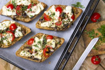 delicious bruschetta with tomatoes, cheese and mushrooms