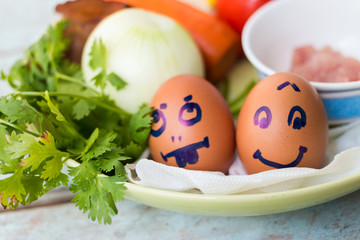 Fresh vegetables, eggs and pork chops. On blue wooden