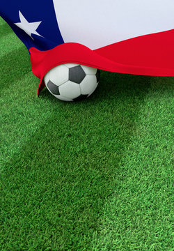 Soccer ball and national flag of Chile,  green grass