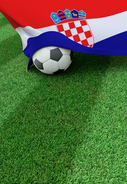 Soccer ball and national flag of Croatia,  green grass