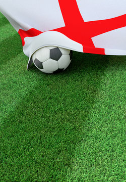 Soccer ball and national flag of England,  green grass