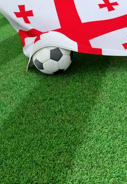 Soccer ball and national flag of Georgia,  green grass