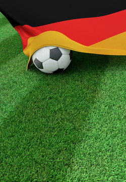Soccer ball and national flag of Germany,  green grass