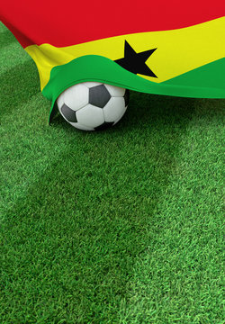Soccer ball and national flag of Ghana,  green grass