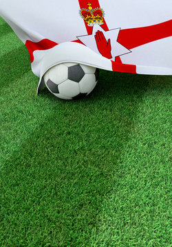 Soccer ball and national flag of Northern Ireland,  green grass