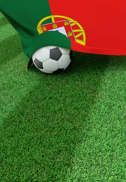 Soccer ball and national flag of Portugal,  green grass