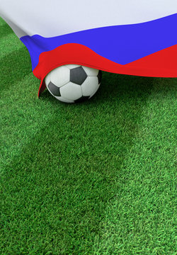 Soccer ball and national flag of Russia,  green grass