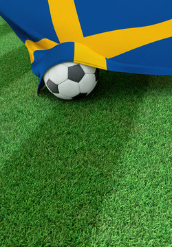 Soccer ball and national flag of Sweden,  green grass