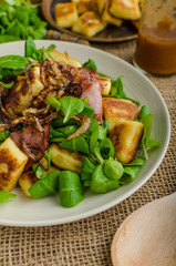 Potato gnocchi with salad and onions