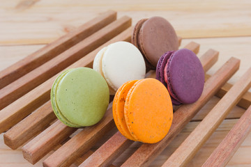 Colorful French Macarons On wood panel