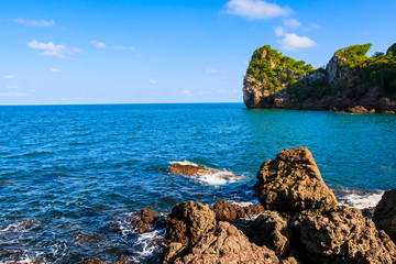 Background stone beach, with blue sky and sand