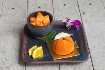 Dessert - Mousse Cake with Orange Sauce Cantaloupe and orange fruit