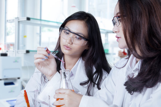 Two female scientists doing experiment