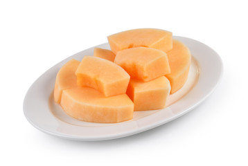 sliced cantaloupe melon on white plate on white background