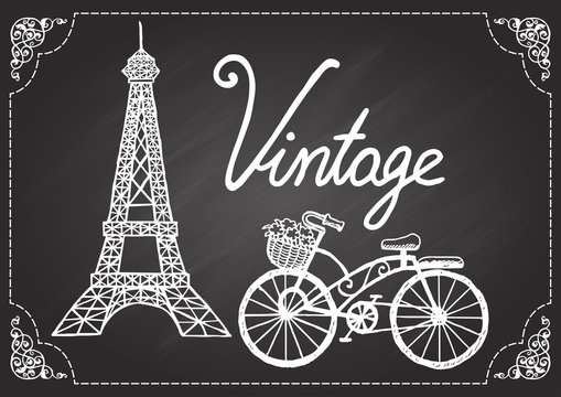 Hand drawn Eiffel tower and vintage bicycle on chalkboard with ornamental swirl