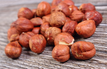 Heap of brown hazelnut on wooden table