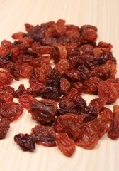Brown raisins on wooden table, healthy eating
