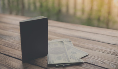 Blank passport with US dollars on wood table ( Filtered image pr
