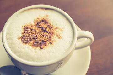 Hot latte art coffee on table ( Filtered image processed vintage