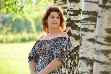 woman in a dress with open shoulders is about Birch