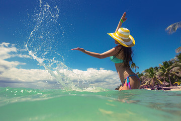 Carefree young woman relaxing on tropical beach