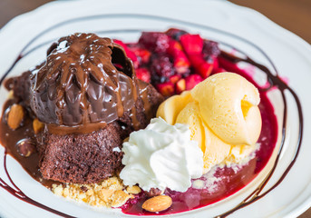 Chocolate cake with fruit peach, black currant, blueberry, apple