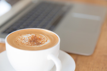 laptop with coffee cup on old wooden table ( Filtered image proc