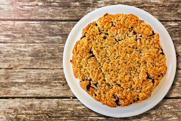 Fresh baked cake, on wooden table. Top view.