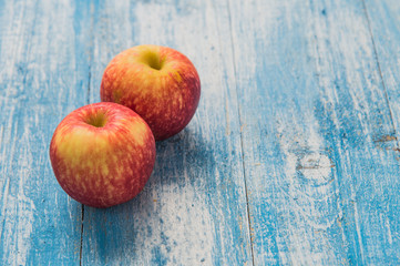 Red apple on the wooden floor.