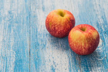 Red apple on the wooden floor.