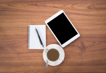 smartphone, tablet and coffee cup with financial documents on wo