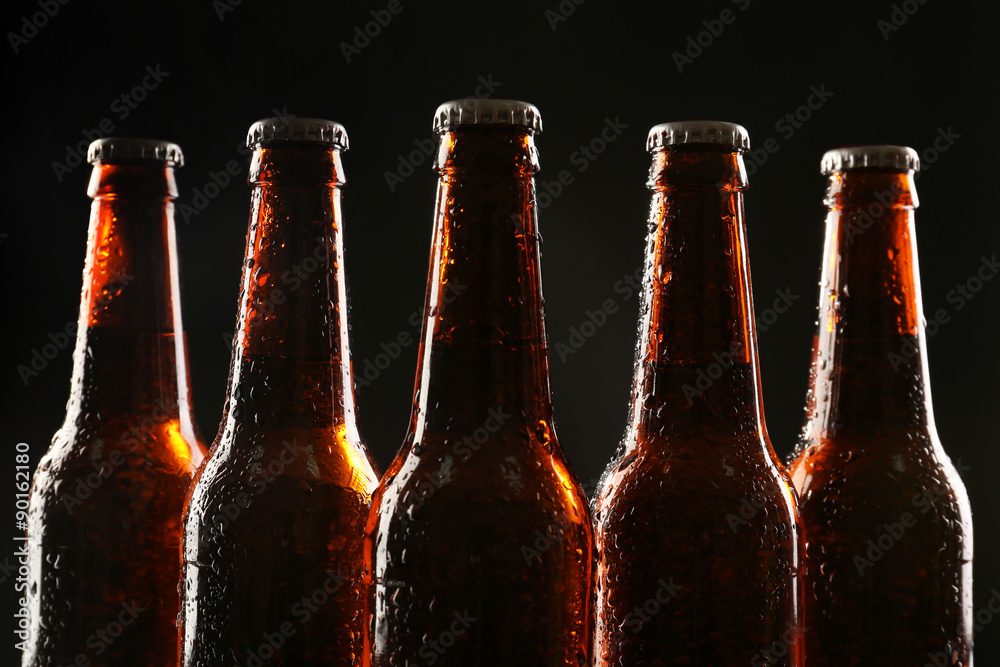 Sticker glass bottles of beer on dark background