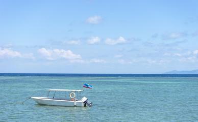 Boat with clean water and blue skies