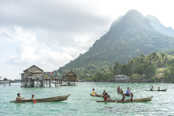 Unidentified Bajau Laut kids on a boat in Bodgaya Island, Sabah, Malaysia. They lived in a house...