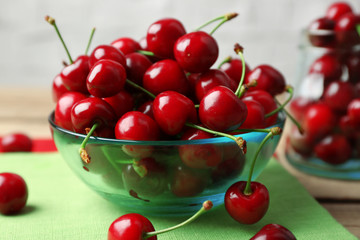 Sweet cherries in bowl on table close up