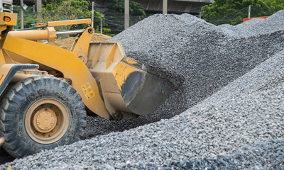 Front end loader dumping stone in a mining quarry