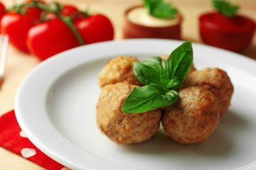 Meat balls on plate, on wooden table background