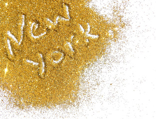 Blurry inscription New York on golden glitter sparkle on white background