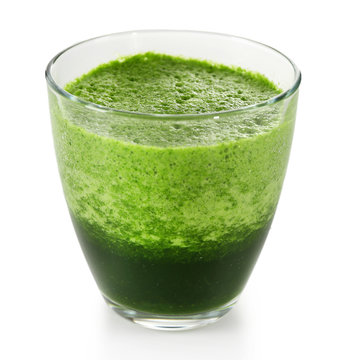 Glass of green vegetable juice isolated on white