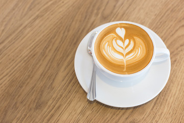 Hot art Latte Coffee in a cup on wooden table
