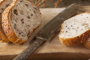 Bread, a set of variation of breads on a wood chopping block with knife