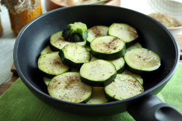 Sliced zucchini in pan on table, closeup