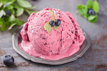 Ice cream with blueberries in a vintage metal ware