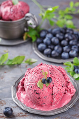 Ice cream with blueberries in a vintage metal ware