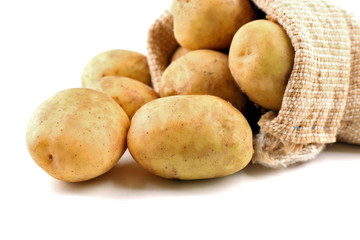 Young potatoes in sackcloth bag isolated on white