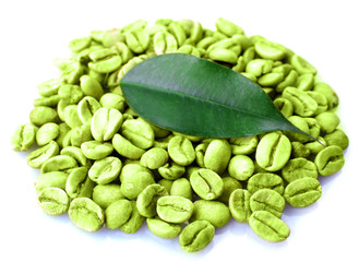 Heap of green coffee beans with leaf isolated on white